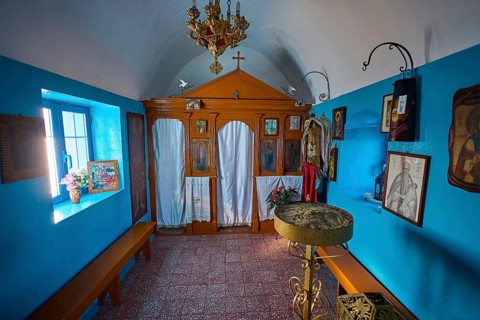 The interior of the church features icons and decorative elements in blue and orange, chapel,