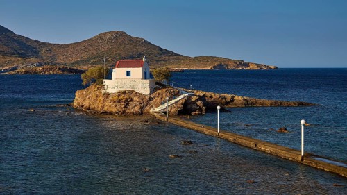 Quiet, peaceful coastal scene with chapel on rocky island, surrounded by blue water, chapel,