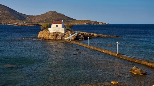 Calm scene with chapel on rocks in the sea under morning light, chapel, church, Agios Isidoros,