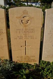 A gravestone with the emblem of the Royal Air Force, inscribed with personal and military