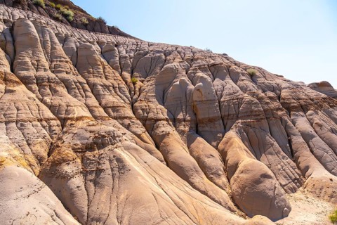 Sunlight illuminates the unique geological formations known as hoodoos. Showcasing layers of