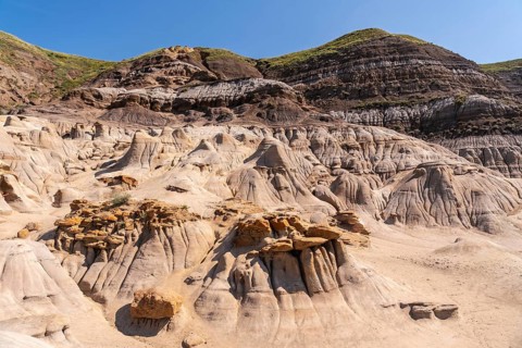 Breathtaking panoramic view of the arid drumheller valley showcasing unique hoodoo formations under
