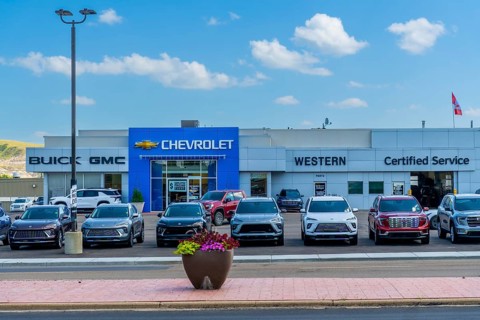 Modern car dealership displaying a variety of new vehicles, representing brands such as buick, gmc,