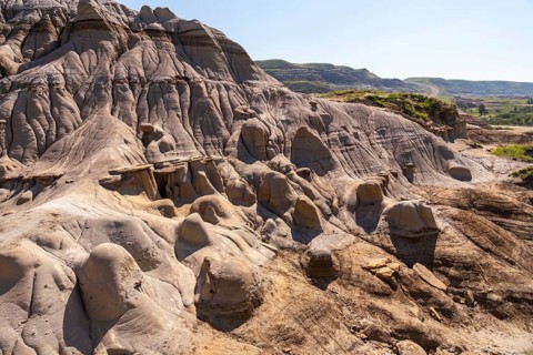 Sunlight illuminates the hoodoo badlands in drumheller, canada, showcasing unique rock formations