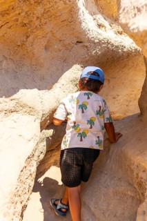 Young adventurer discovering extraordinary sandstone formations in drumheller, canada, while