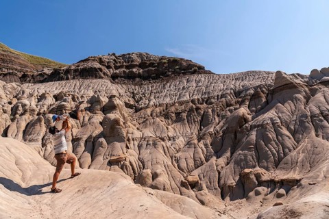 Tourist father is lifting his son in the air in the otherworldly landscape of the canadian