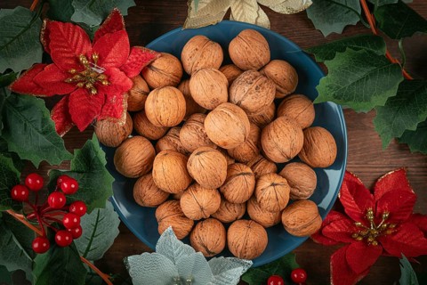 Blue plate with walnuts decorated with Christmas decoration