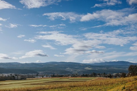 Wide fields and hills under a vast sky with loose clouds, Ternitz, Lower Austria, Austria