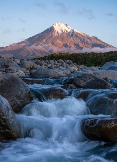 Mount Taranaki in the evening at sunset, in the foreground Stony River (Hangatahua River) . Egmont
