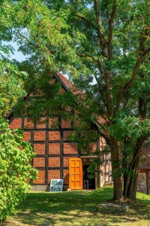 Sign open church in front of the half-timbered church in the village of Carwitz, Feldberger