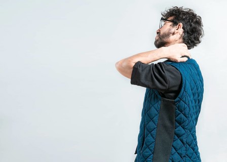 Suffering young man with stress and neck pain. Fatigued man with neck pain isolated