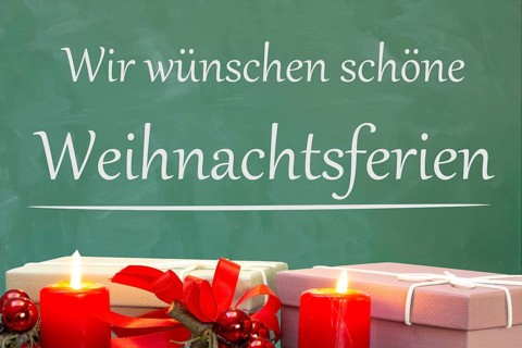 (Photo montage) Christmas decoration on a school blackboard with the inscription WE WISH YOU HAPPY