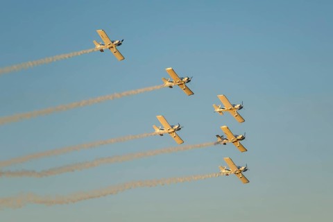 Stunt aerobatic planes performing stunts in blue sky with smoke trail. Concept of teamwork,