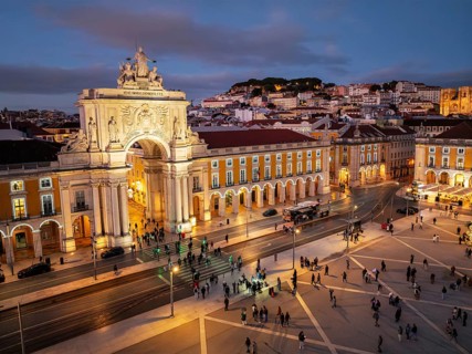 Experience the magic of Christmas in Lisbon as Praca do Comercio glows with festive lights in the