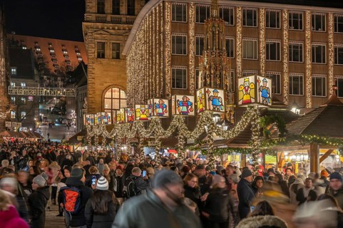 Nuremberg Christmas Market illuminated in the evening with the Beautiful Fountain and Town Hall,