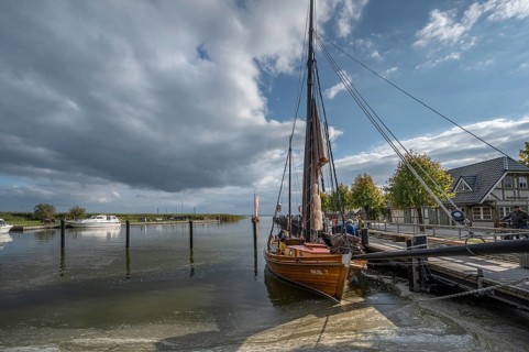 Historic sea boat, formerly used for sailing fishing, anchored in the port of Ahrenshoop,