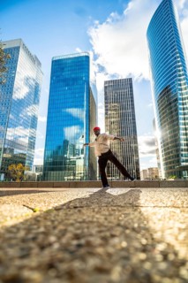 African american man maintaining balance on one leg with outstretched arms, performing street dance