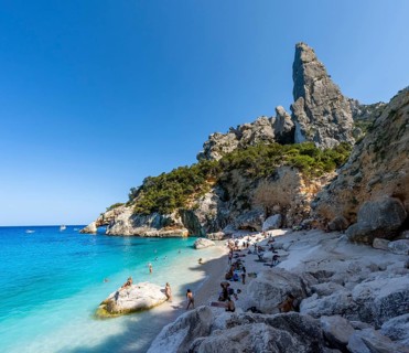 Light blue clear sea on a dream beach on Cala GoloritzÃ©, picturesque rocky coast, steep coast with