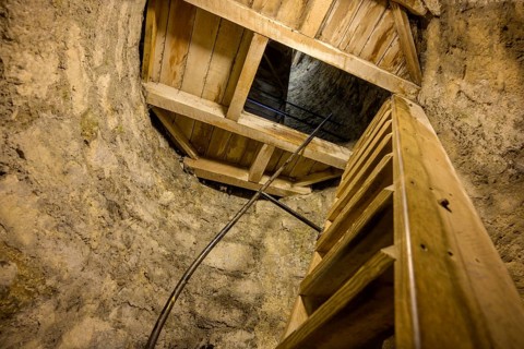 Climb over narrow wooden stairs in the round tower, St. Canice's Cathedral, Kilkenny, County