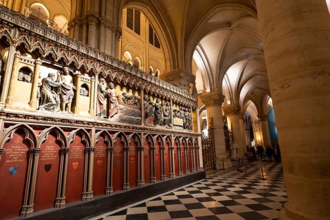 Notre dame cathedral interior with ornate gothic choir screen of detailed biblical sculptures,