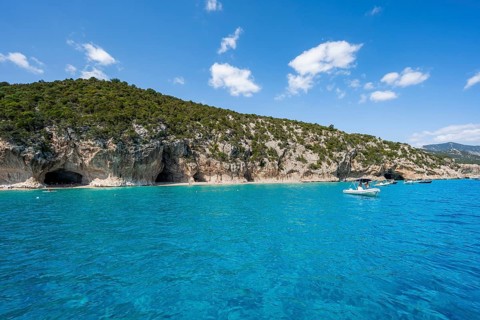 Clear blue water and picturesque rocky coast, Cala Luna cliffs and beach, Golfo di Orosei, Baunei,
