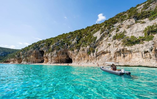 Turquoise clear water and picturesque rocky coast, Cala Luna cliffs and beach, Golfo di Orosei,
