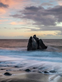 Sunset, waves and rocks in the sea, Praia Formosa, Madeira, Portugal