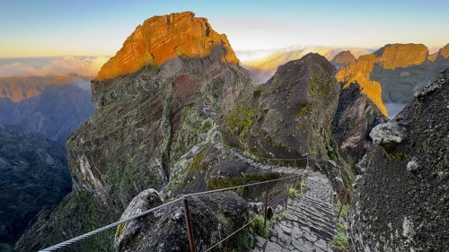 Sunrise at Pico do Arieiro, clouds of fog pass over mountain peaks, hiking trail PR1, Madeira,