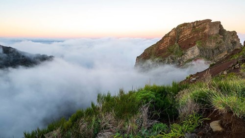 Sunrise at Pico do Arieiro, clouds of fog sweep over mountain peaks, sea of fog, hiking trail PR1,