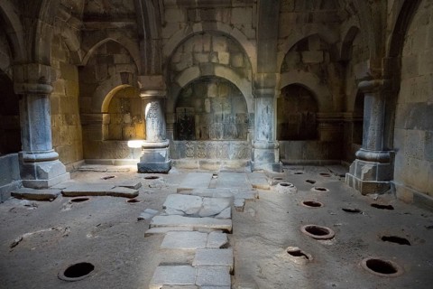 Arched stone interior with floor openings and atmospheric lighting through ancient arches, Haghpat