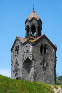 Single pointed stone turret on a hill against a blue sky, Haghpat Monastery, Haghpatavank, Haghpat