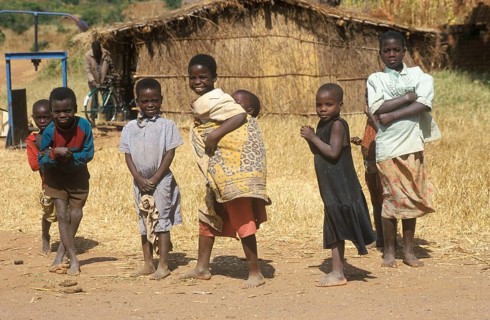 Children in front of a straw hut on the side of the road, Bwangu Mzimba, Malawi, Africa, June 2000,