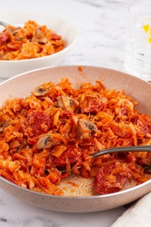 Bigos, Polish dish bigos, on the table, pan with stewed meat, with cabbage, chorizo sausages,