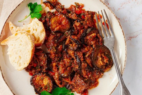 Stewed meat with eggplant is a Georgian dish, on a light background, homemade, no people