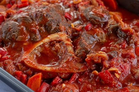 Ossobuco stew with vegetables, knuckle on the bone with new potatoes, in tomato sauce, homemade,