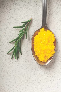 Yuzu caviar is pearly, on a spoon, top view, light background, no people