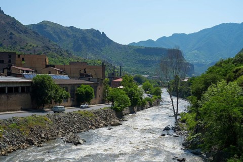 Industrial building along a river in a mountainous and green area, former copper smelter, Alaverdi,