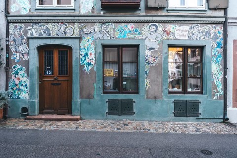 House faÃ§ade with paste-up street art, Basel
