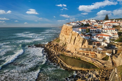 Scenic view of the seaside Azenhas do Mar fishing village on cliff on Atlantic ocean coast,