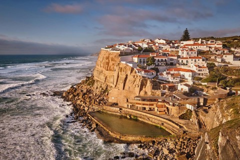 Scenic view of the seaside Azenhas do Mar fishing village on cliff on Atlantic ocean coast,