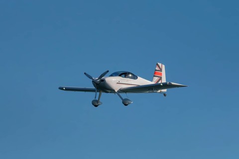 Stunt aerobatic plane performing stunts in blue sky. Concept of speed, difficulty, precision, risk,