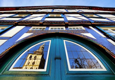 Door detail on the half-timbered house Altes brewhouse with the reflection of the church tower of