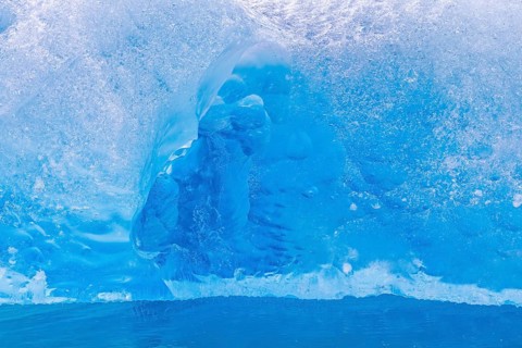 Close-up of blue ice floe calved from Lilliehöökbreen glacier drifting in the Lilliehöökfjorden,