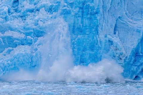 Ice chunk breaking from edge of the calving Lilliehöökbreen glacier into Lilliehöök Fjord,