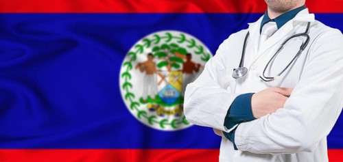 Belize healthcare concept. Male doctor on Belizean flag. Doctor with crossed arms on Belize flag