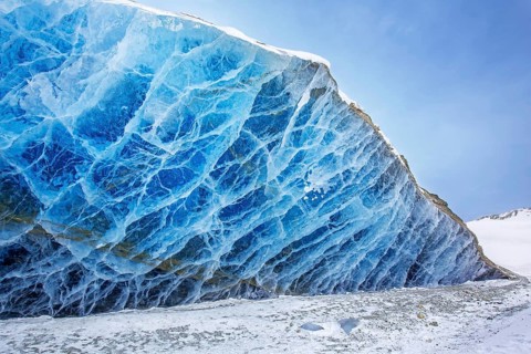 Glacier wall showing smooth melting blue ice made of compressed snow, Spitsbergen / Svalbard,