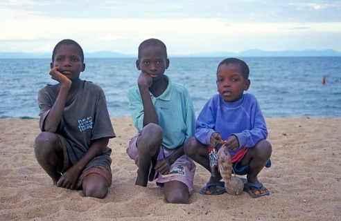 Three local boys posing for the camera on the beach, Chitimba, Lake Malawi, Africa, July 2000,