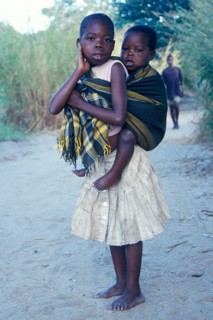 Girl carrying younger sibling at Kande Beach, Malawi, Africa, July 2000, vintage, retro, old,