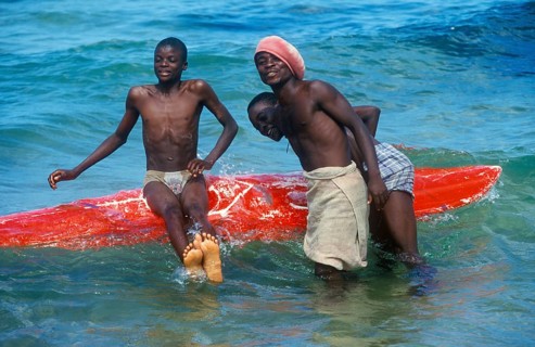 Teenager with surfboard in Lake Malawi, Kande, Malawi, Africa, July 2000, vintage, retro, old,