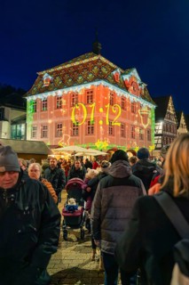 Projection with time on a building during a night-time Christmas market, Christmas market 2025,